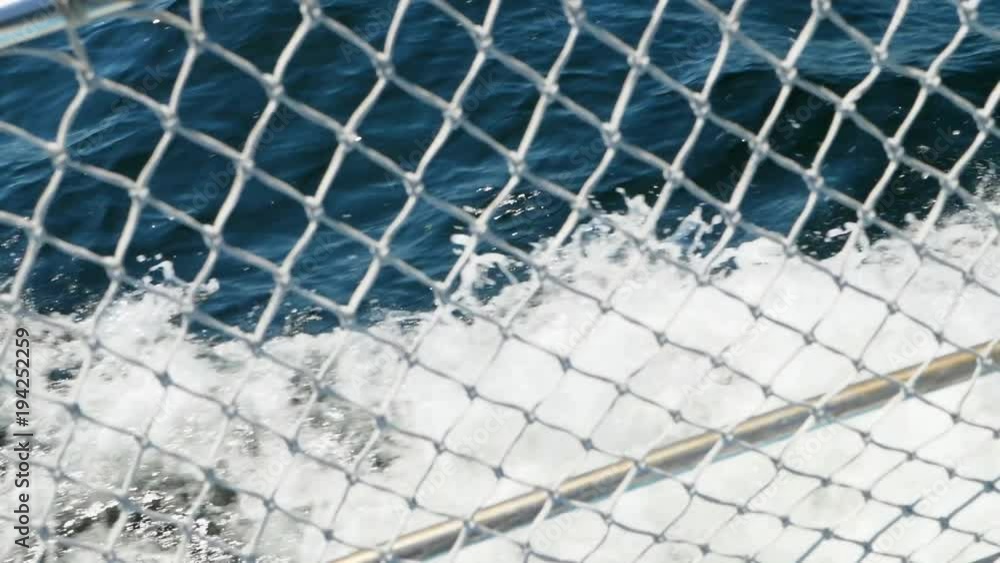 Slow motion of boat with bouy cruising through ocean water Slow motion of boat with bouy cruising through ocean water