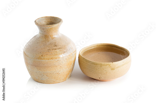 Japanese Sake drinking in ceramic jars and ceramic glass isolated on a white background