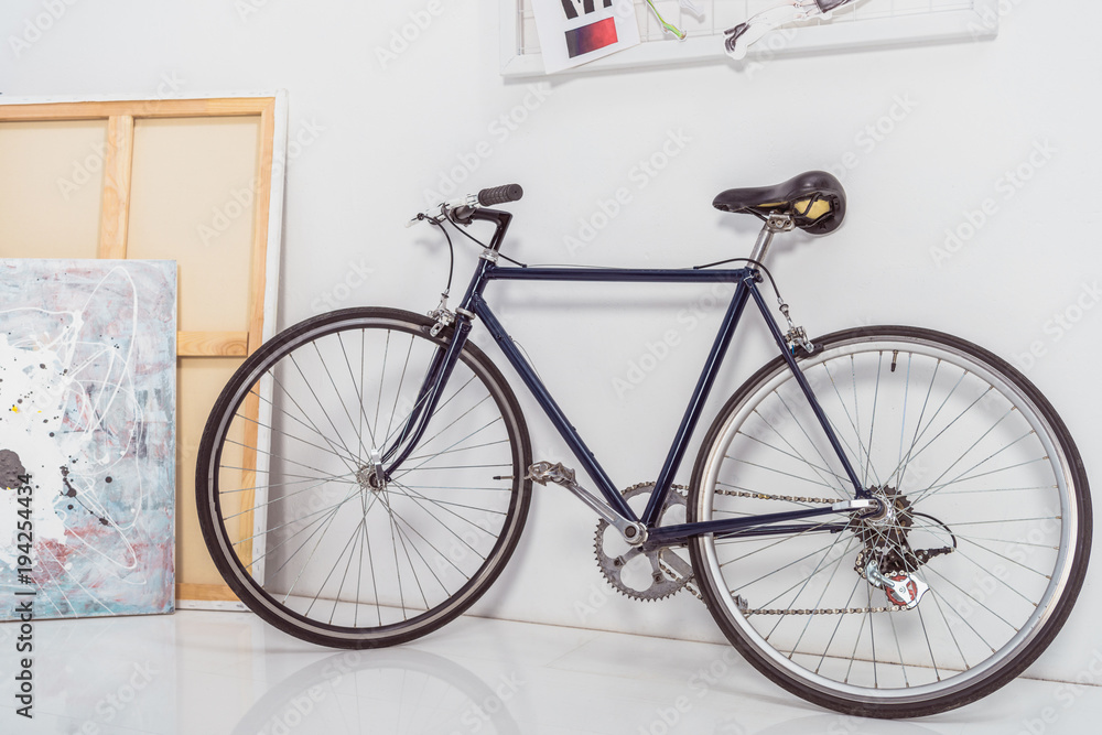 Bicycle by the wall in stylish light room