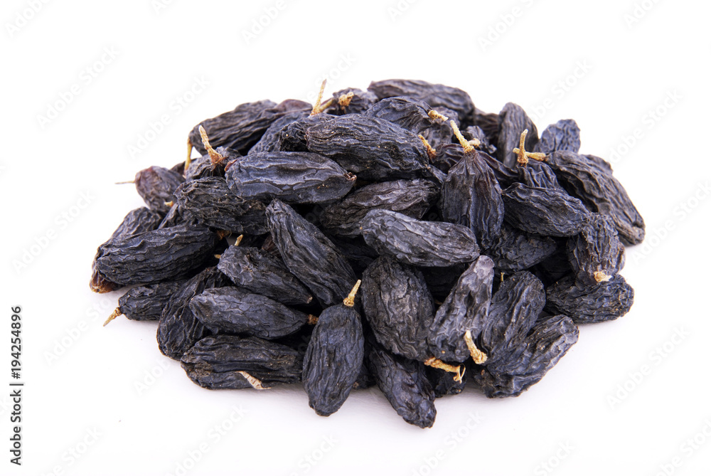 Dark raisins on a white background. Dark raisins on a white background.