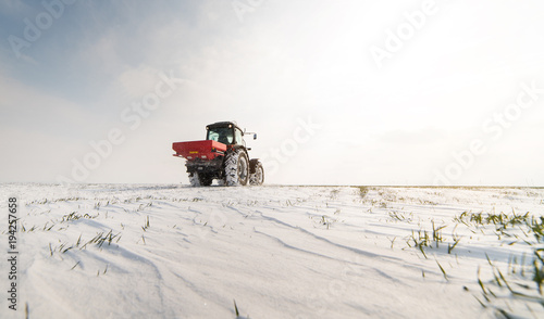 Farmer with tractor seeding - sowing crops at agricultural fields in winter © Dusan Kostic