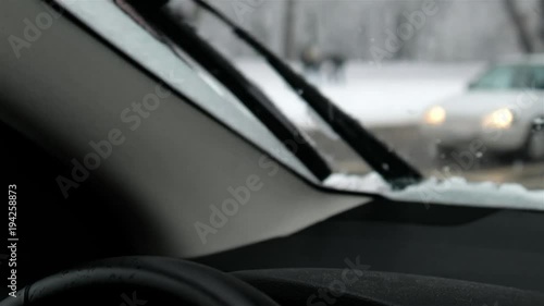 Unsteady shot of beanies in a car while person walks by during the winter photo