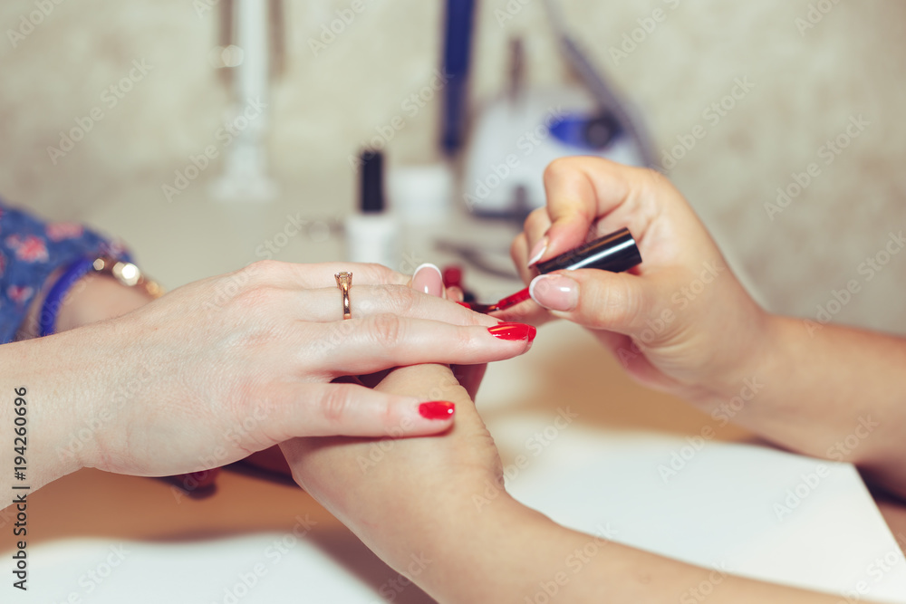Woman doing manicure in beauty salon. Woman doing manicure in beauty salon.