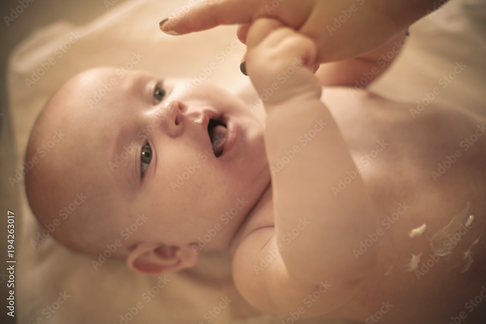 Baby with dab of lotion on body. Close up. Baby with dab of lotion on body. Close up.