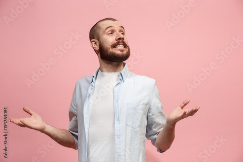 The happy business man standing and smiling against pastel background.