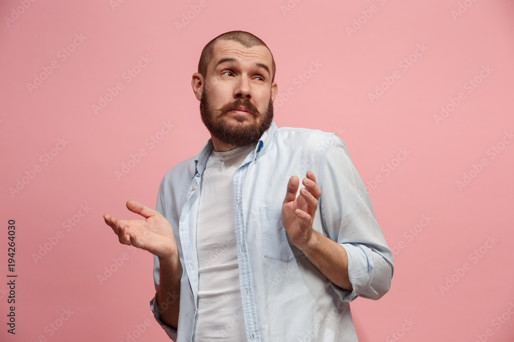 Let me think. Doubtful pensive man with thoughtful expression making choice against pink background Let me think. Doubtful pensive man with thoughtful expression making choice against pink background