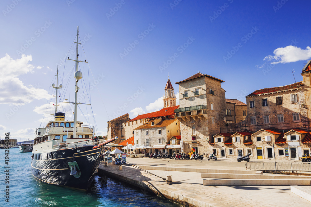 Trogir town, Croatia. View of the old town and sailing ship. Famous Croatian tourist destination. Dalmatian coast
