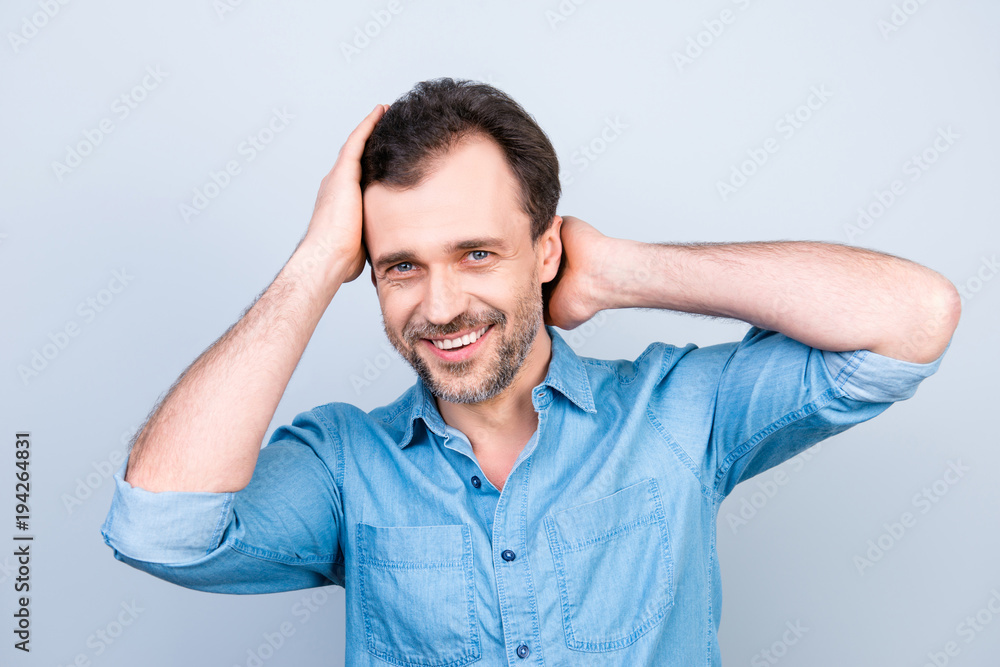 Close up portrait of attractive handsome cheerful excited satisfied glad brunette man with toothy beaming smile checking haircut in mirror after visiting barbershop isolated on gray background Close up portrait of attractive handsome cheerful excited satisfied glad brunette man with toothy beaming smile checking haircut in mirror after visiting barbershop isolated on gray background