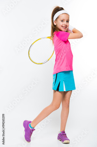 Cute little girl with tennis racket in her hands on white background