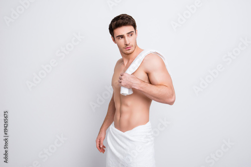 Portrait of confident stunning dreamy athletic sporty guy holding towel on shoulder, he is going after morning shower, isolated on white background with copy space © deagreez