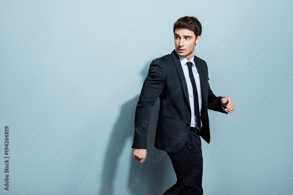 Half-turned portrait of handsome busy confident attractive serious minded thoughtful stunning entrepreneur going somewhere gesturing with hands looking to the back isolated gray background copy-space Half-turned portrait of handsome busy confident attractive serious minded thoughtful stunning entrepreneur going somewhere gesturing with hands looking to the back isolated gray background copy-space