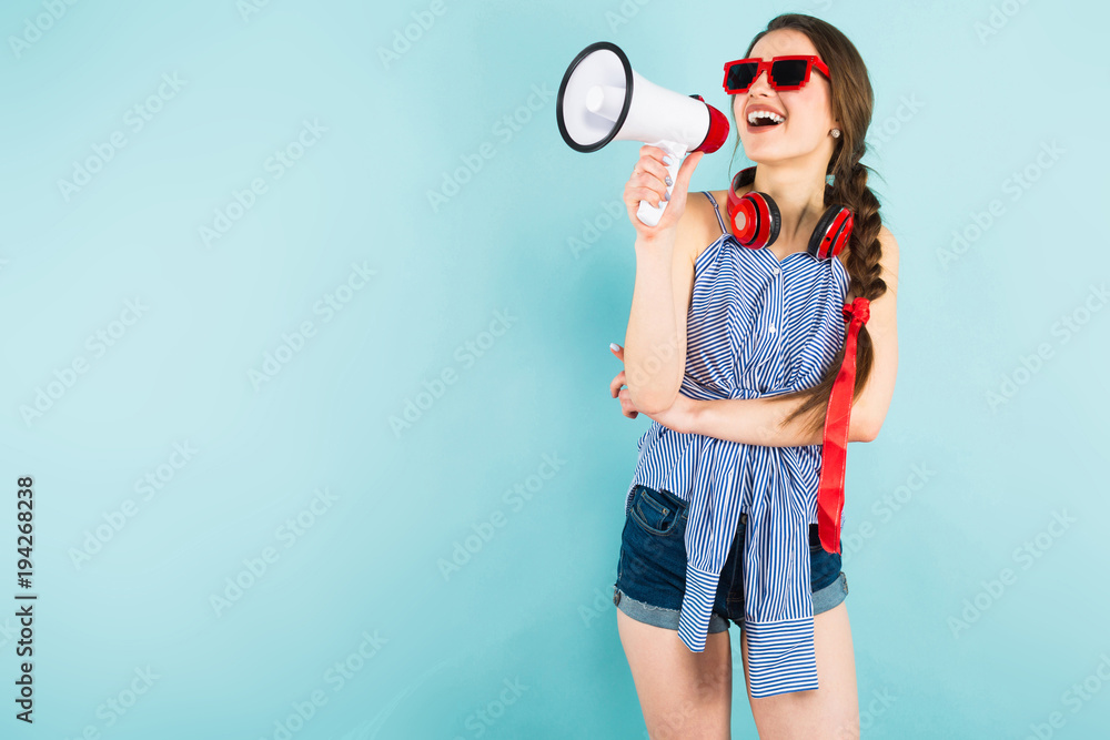 Young sexy woman with headphones and loudspeaker Young sexy woman with headphones and loudspeaker