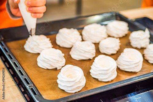 Making tasty meringues with pastry bag photo