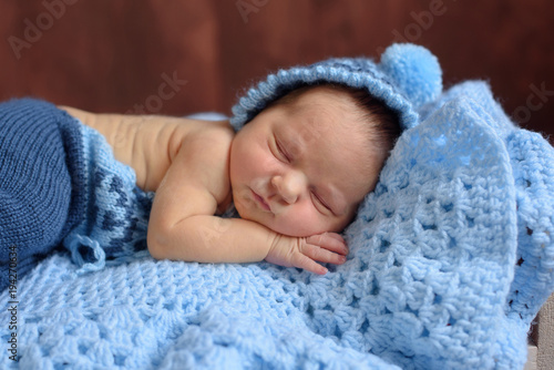 sleeping newborn baby on a blue blanket