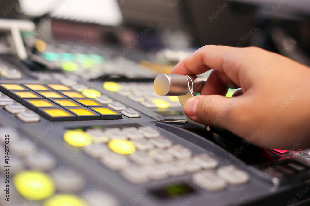 Hands on dissolve of Switcher buttons in studio TV station, Audio and Video Production Switcher of Television Broadcast. Hands on dissolve of Switcher buttons in studio TV station, Audio and Video Production Switcher of Television Broadcast.