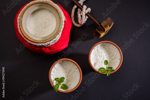 Lassie or lassi in terracotta glass - Lassi is an Authentic Indian cold drink made up of curd and milk and sugar, selective focus
 photo