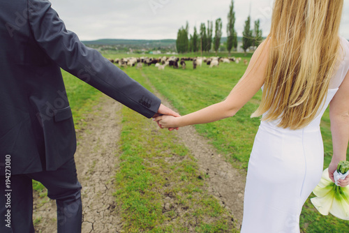 Couple Holding Hands in Field