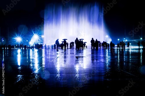 People looks the light and music fountain show. Dancing water