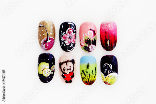 many plastic pink tips for nail extension and training in applying design while training a manicure. trial student work in the form of monograms, flowers and animals, with pasted pastes.
