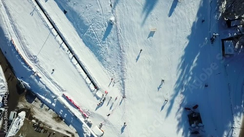 Kids are skiing downhill and are having fun. This is Celjska koca resort close to the town of Celje. Aerial shot. photo