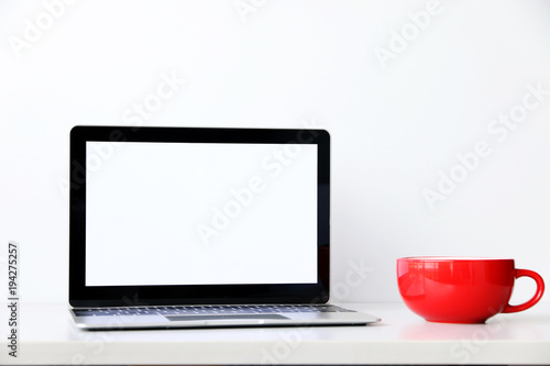 workspace desk with laptop and Red Coffee Cup business and technology concept.space for your text.