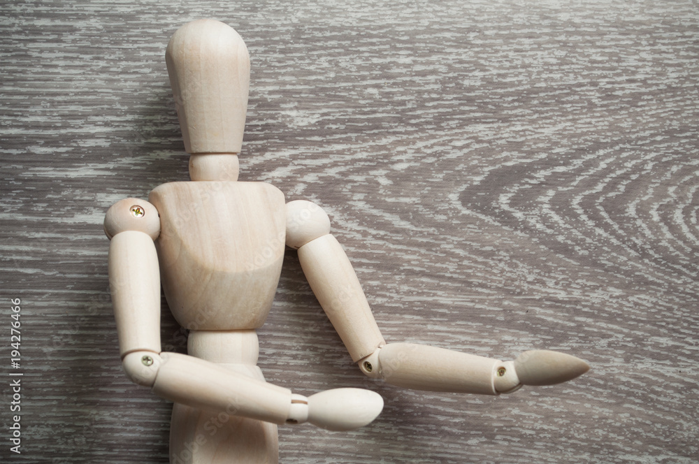 closeup of wooden mannequin on grey wooden background closeup of wooden mannequin on grey wooden background
