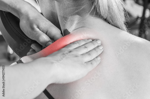 Картината върху платно Chiropractor, physiotherapist examining her patient back and doing decontracting massage