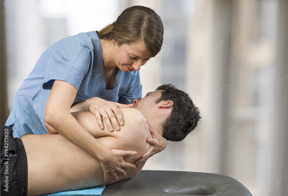 Physiotherapist doing manipulation to man patient. Osteopathy Physiotherapist doing manipulation to man patient. Osteopathy