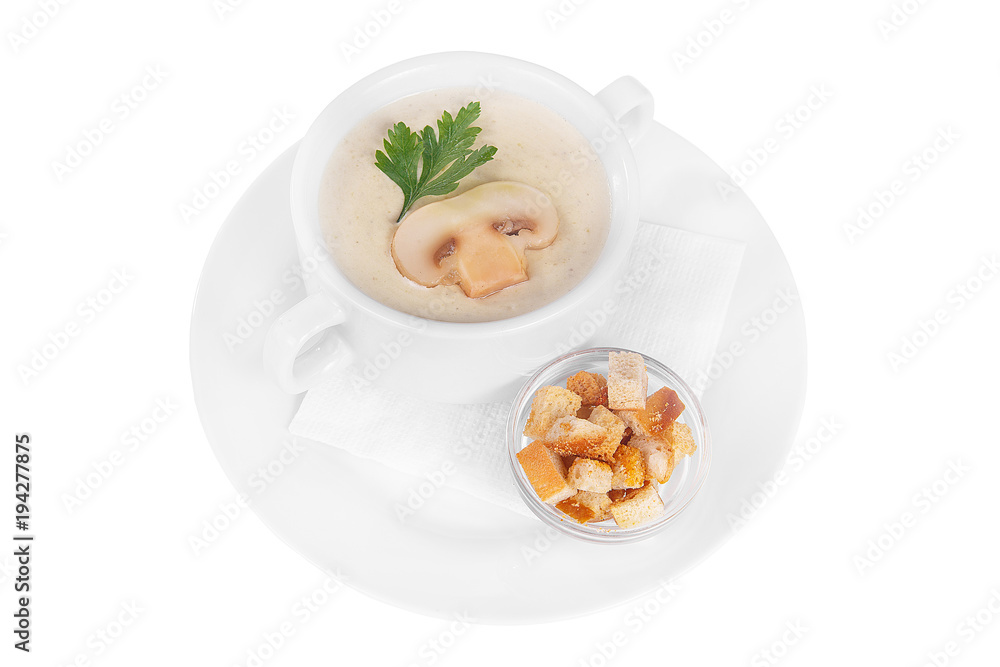 Soup puree, cream soup white, beige with mushrooms, championons and crackers, dry bread. On a napkin in a white plate isolated white. Serving dishes in a cafe, restaurant, for a menu. Side view Soup puree, cream soup white, beige with mushrooms, championons and crackers, dry bread. On a napkin in a white plate isolated white. Serving dishes in a cafe, restaurant, for a menu. Side view