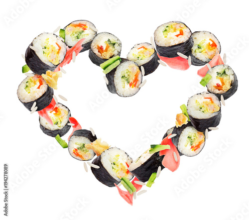 Sushi rolls frozen in the air in the shape of the heart