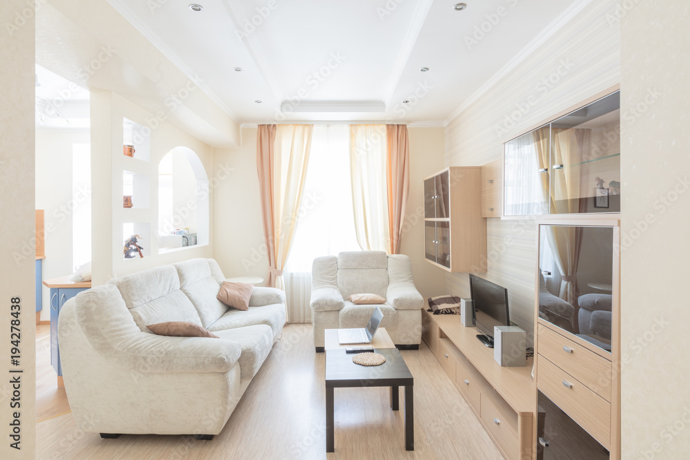 bright living room with soft white sofa and small table bright living room with soft white sofa and small table