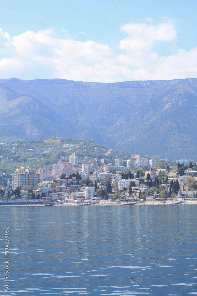 City at the foot of the mountains. View from the sea