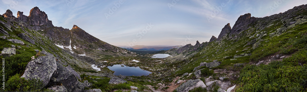 Panoramic photo of the spring mountain valley natural Park Ergaki, Russia. Fabulous sunrise and sunset in the mountains, amazing nature, spring in the mountains. Travel and hike