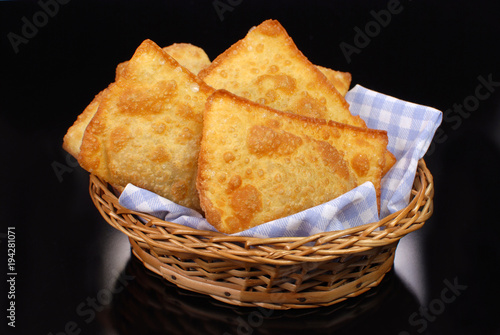 Brazilian typical pastry called pastel in black background 