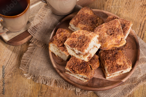 Overhead view of pieces of cinnamon swirl coffee cake on a wooden plate