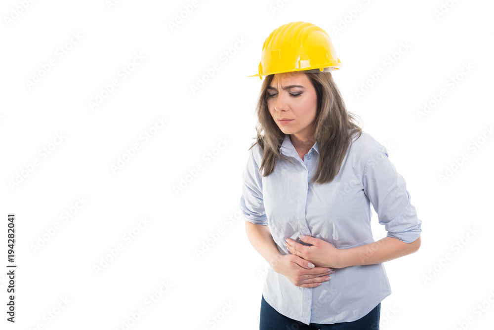 Portrait of female constructor holding her stomach.
