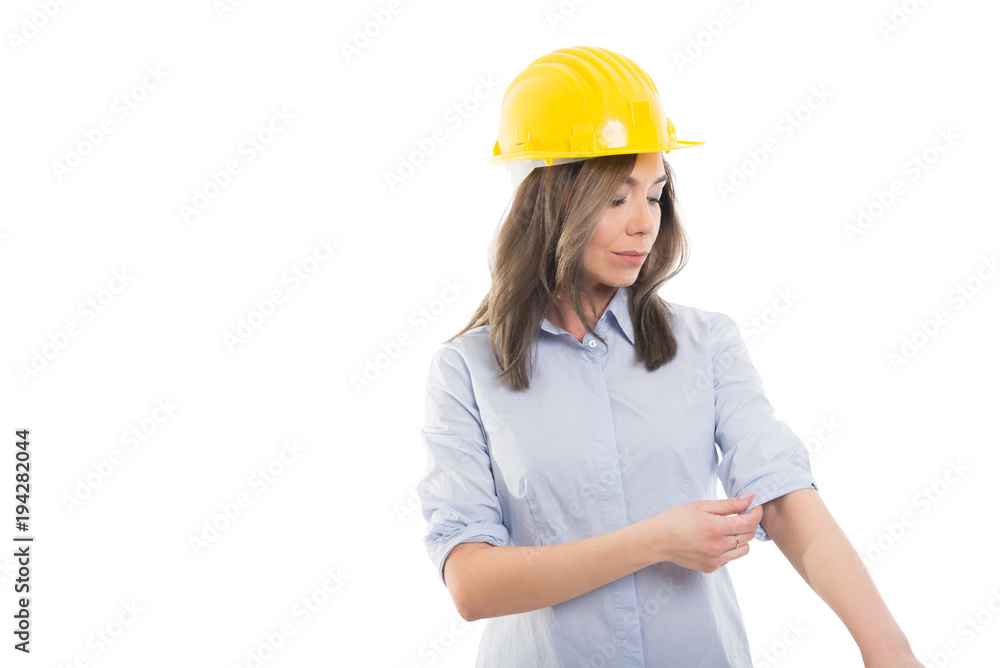 Portrait of female constructor arranging her sleeve.