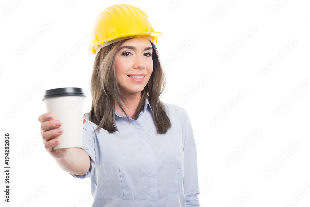 Pretty female constructor offering takeaway coffee. Pretty female constructor offering takeaway coffee.