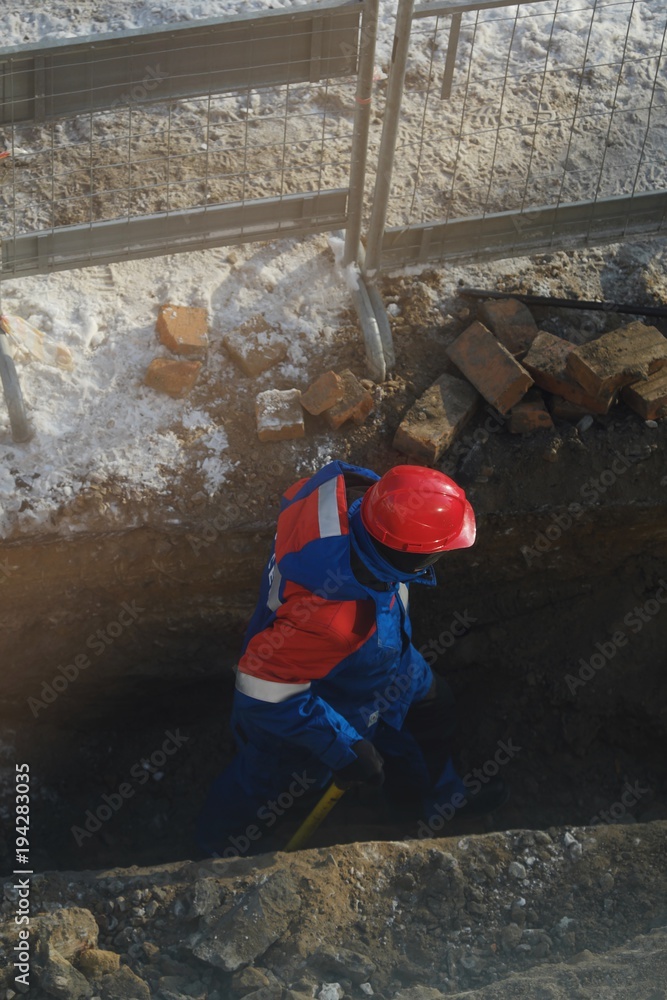 Working men in the form of standing around a sand pit Working men in the form of standing around a sand pit