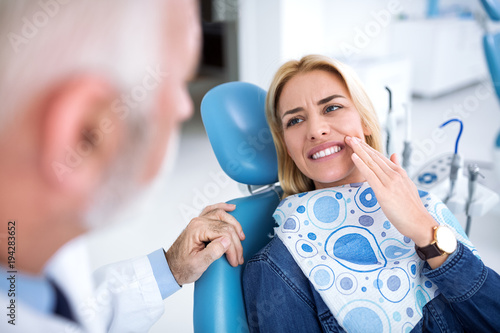 Tableau sur toile A young patient visits the dentist because she has tooth pain
