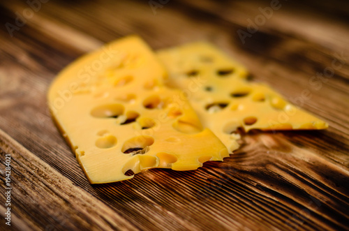 Sliced cheese on wooden table. Selective focus