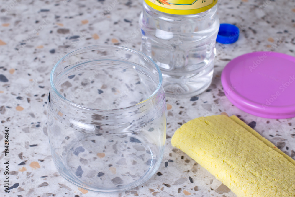 Empty glass jar with a rag for washing on the table Empty glass jar with a rag for washing on the table