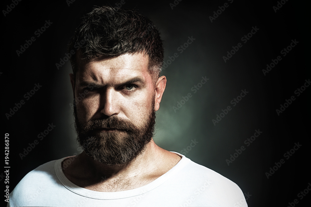 Sexy, athletic male model, serious face, fashionable hairstyle. Portrait of  bearded man face with stylish hairstyle in white shirt. Handsome hipster  with beard and mustache. Copy space for advertising Stock Photo |