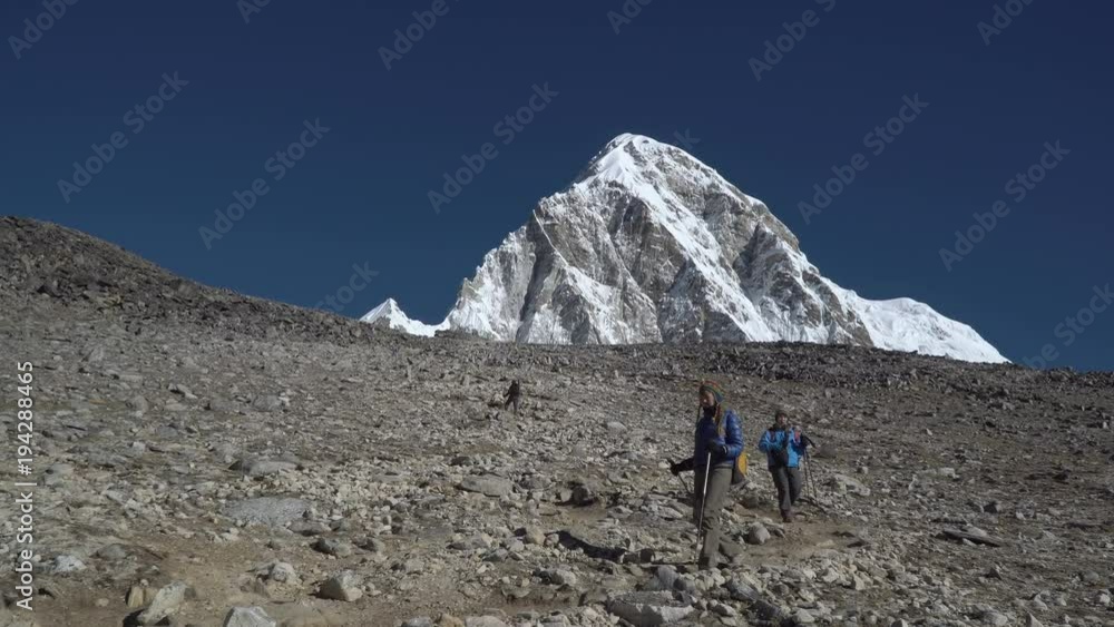 Tourists go on a mountain slope. Travel in the Himalayas. Nepal. 4K Tourists go on a mountain slope. Travel in the Himalayas. Nepal. 4K