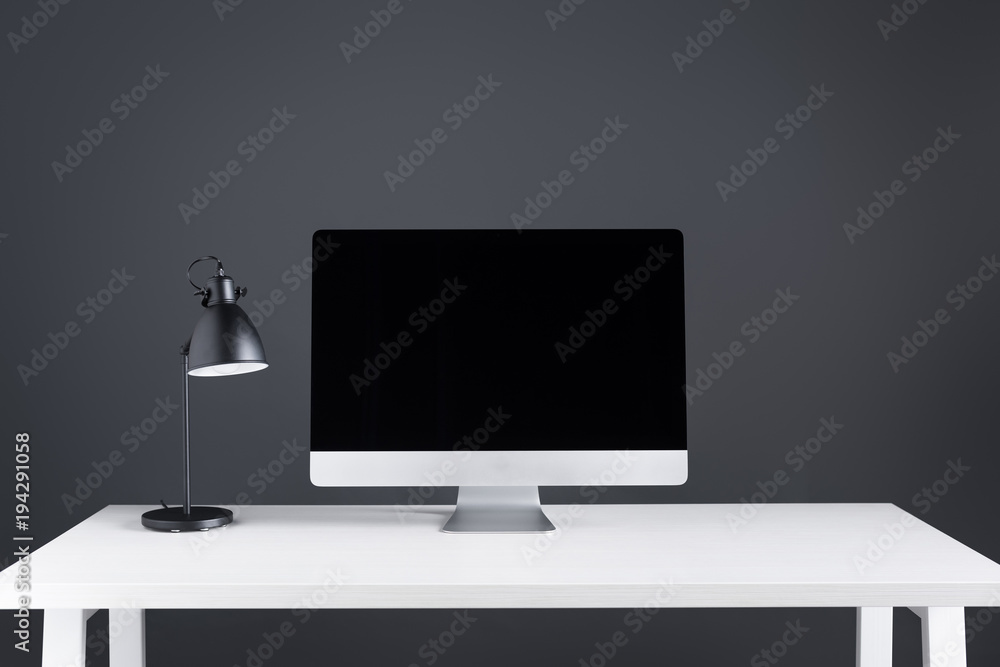 modern desktop computer with blank screen and lamp on table at workspace modern desktop computer with blank screen and lamp on table at workspace