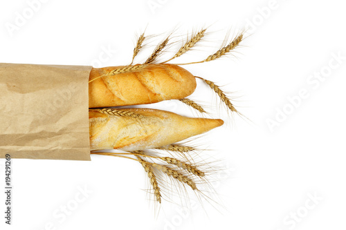 mini baguettes in pacage with wheat on white background photo