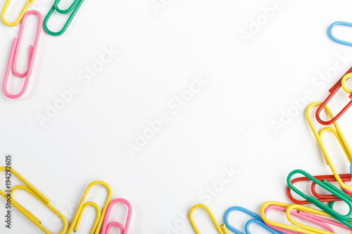 A lot of colorful paper clips on white background.