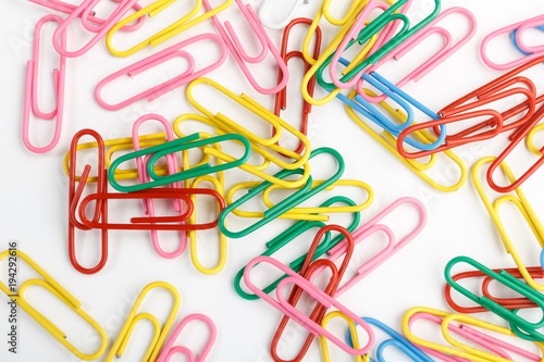 A lot of colorful paper clips on white background.