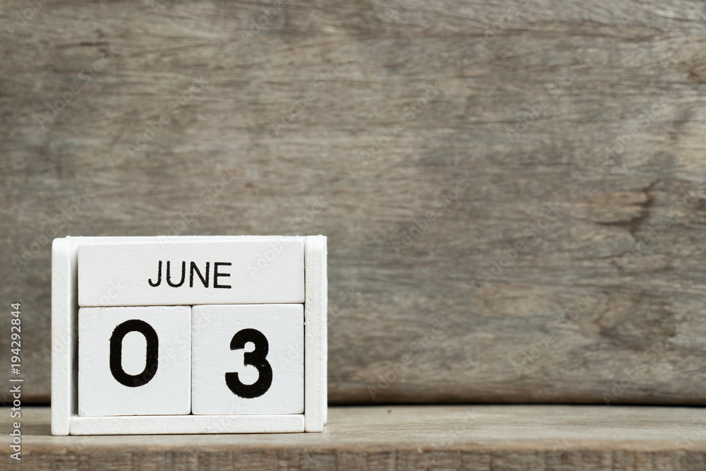 White block calendar present date 3 and month June on wood background White block calendar present date 3 and month June on wood background