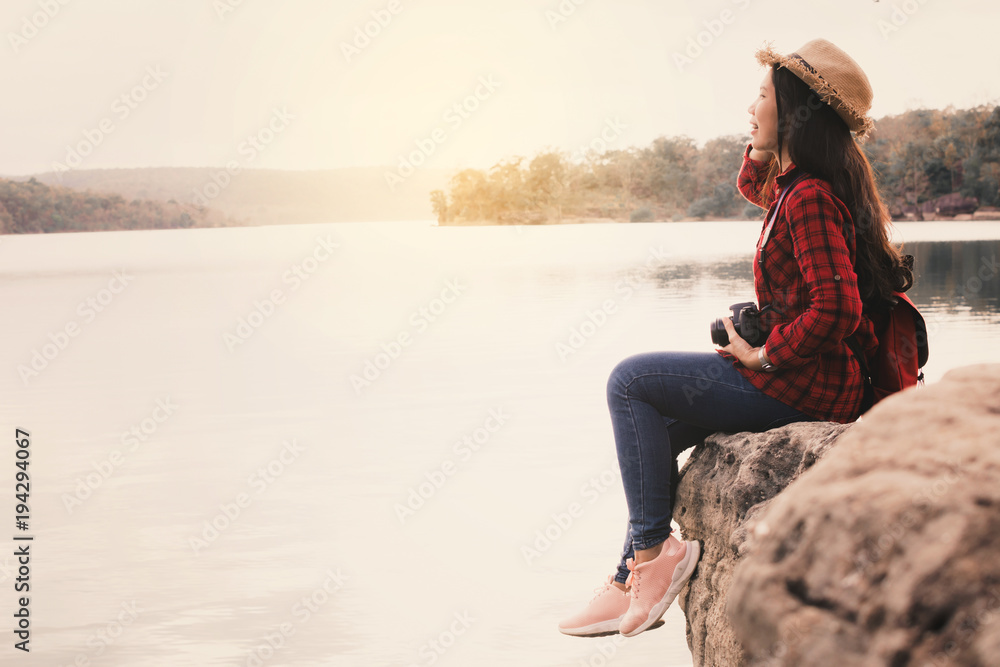 Asian woman shooting picture in nature , Relax time on holiday concept travel,selective and soft focus,tone of hipster style